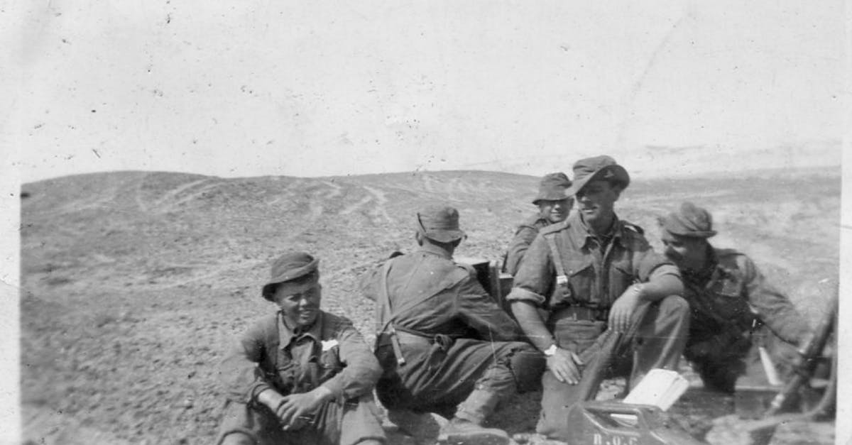 A group of soldiers in a black and white photograph from World War II, outdoors on rugged terrain. World Cup canceled by war