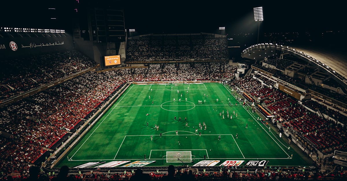 High-angle view of a vibrant football match with enthusiastic fans in a large stadium at night. Greatest Comebacks in World Cup