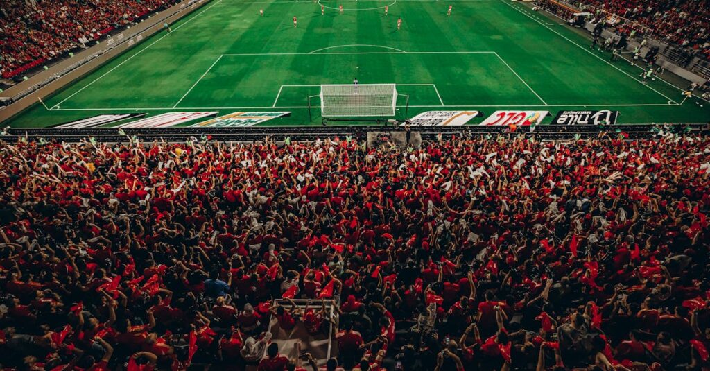 Aerial shot of a lively football match with enthusiastic fans in a packed stadium. - World Cup logistics statistics