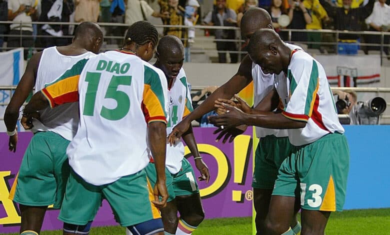 SEOUL, REPUBLIC OF KOREA: Members of the Senegal team celebrate after scoring over France in the opening match of the 2002 FIFA World Cup Korea/Japan tournament in Seoul, 31 May 2002. Senegal jumped out to a 1-0 first half lead over defending world champions France in their opening Group A match
