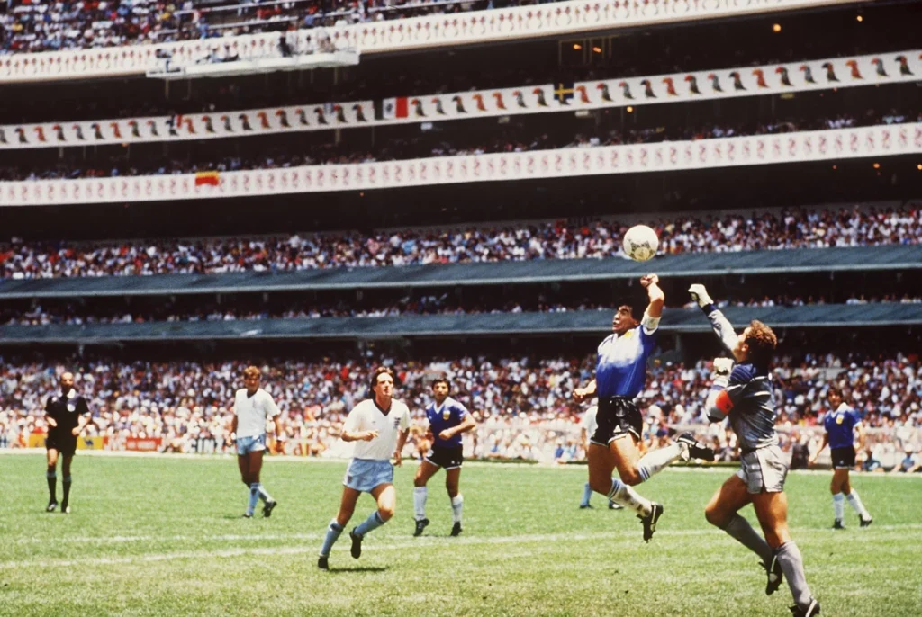 Diego Maradona scoring the Hand of God goal with his hand against England in 1986.