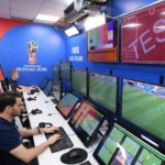 Referee consulting VAR screen during 2018 World Cup match.