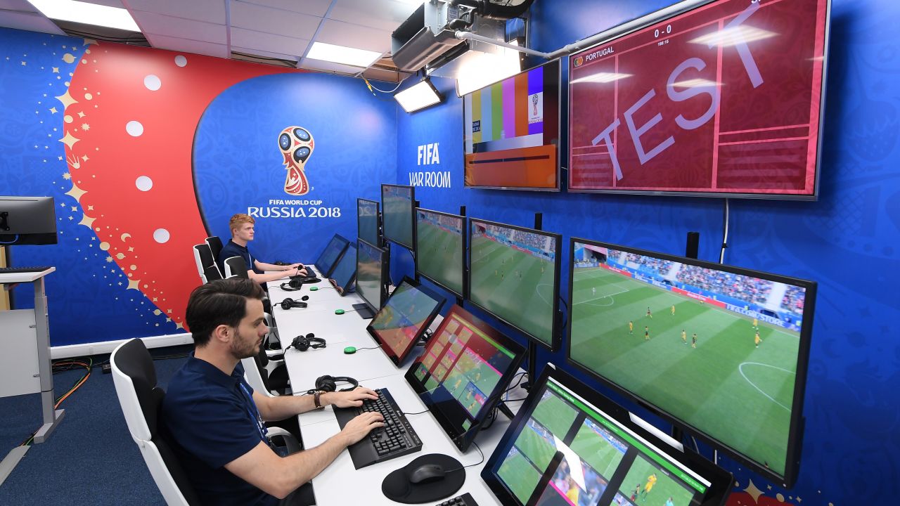 Referee consulting VAR screen during 2018 World Cup match.