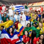 Fans from different nations celebrating together in World Cup fan zone.