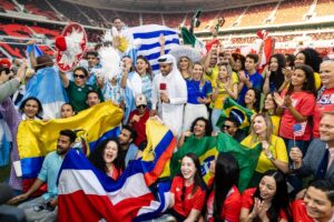 Fans from different nations celebrating together in World Cup fan zone.