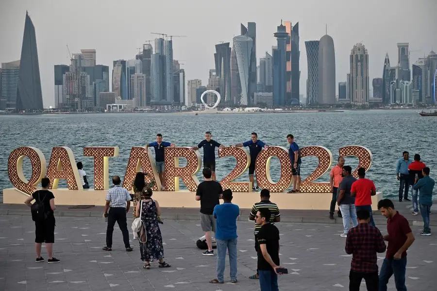 Tourists visiting host city landmarks during World Cup event.